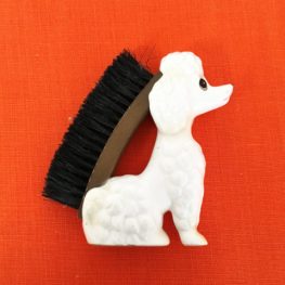poodle clothes brush , kitsch china
